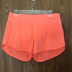 Speed up mid rise 4 inch shorts in sunset. Size 8. Never been worn